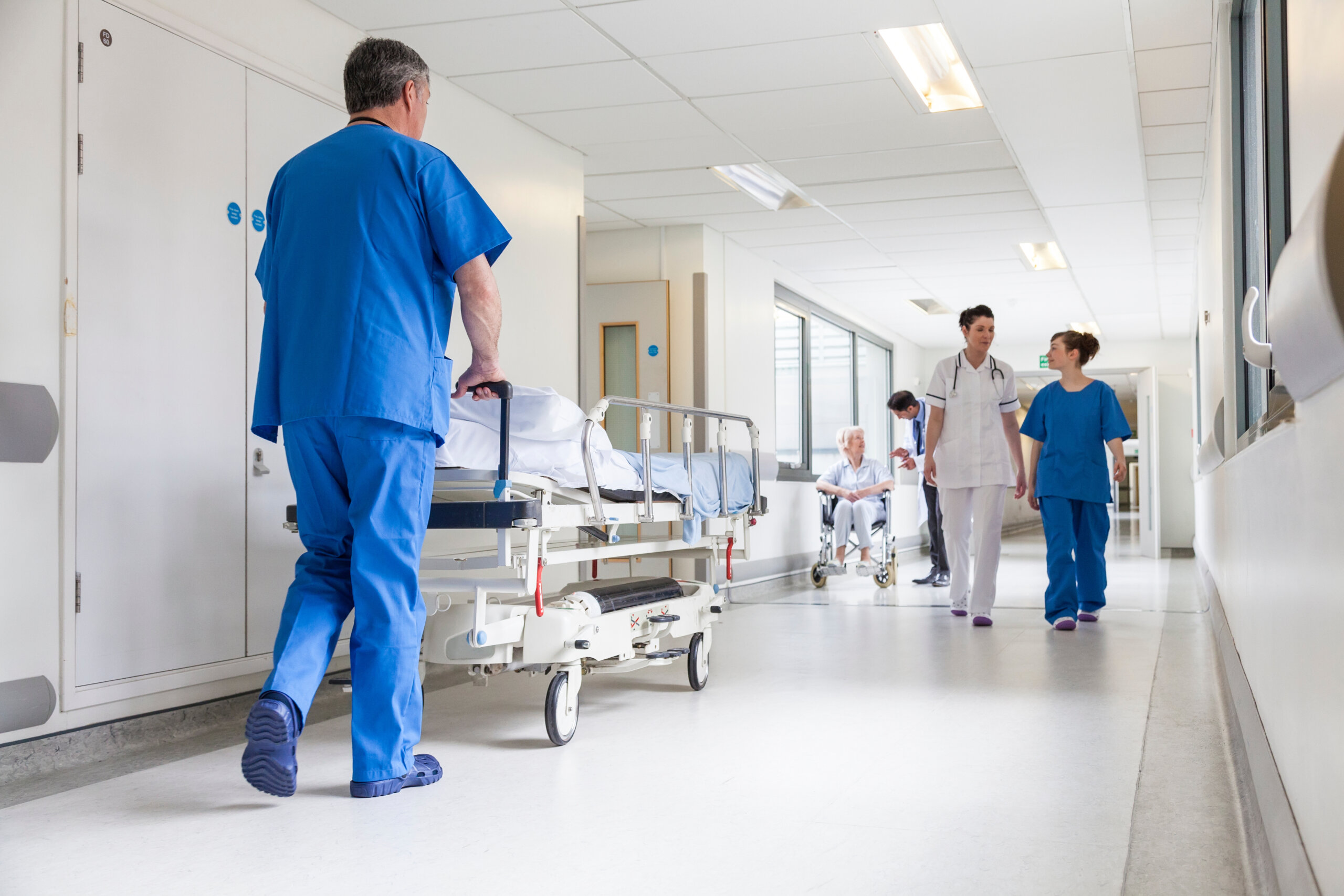 Doctors Hospital Corridor Nurse Pushing Gurney Stretcher Bed